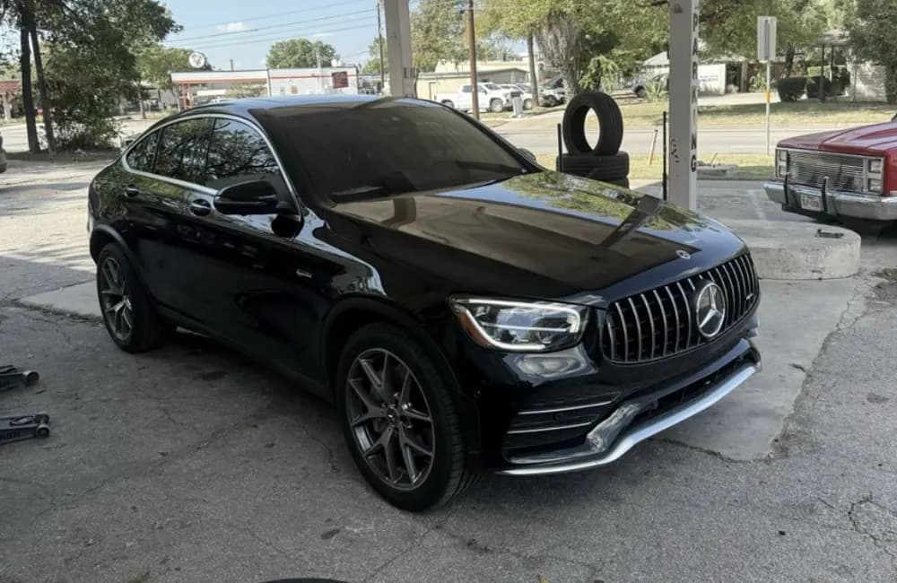 Black Mercedes-AMG GLC Coupe with window tint installed, outside the Shade Customs shop in Georgetown, Texas