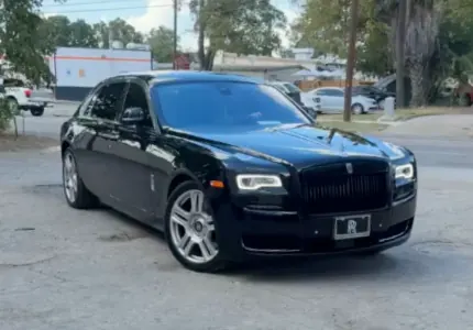 Black Rolls-Royce Ghost with window tint installed, outside the Shade Customs shop in Georgetown, Texas