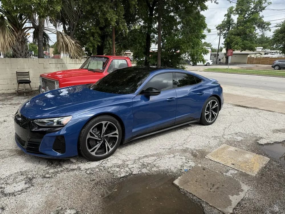 Blue Audi RS e-tron GT with window tint installed, outside the Shade Customs shop in Georgetown, Texas
