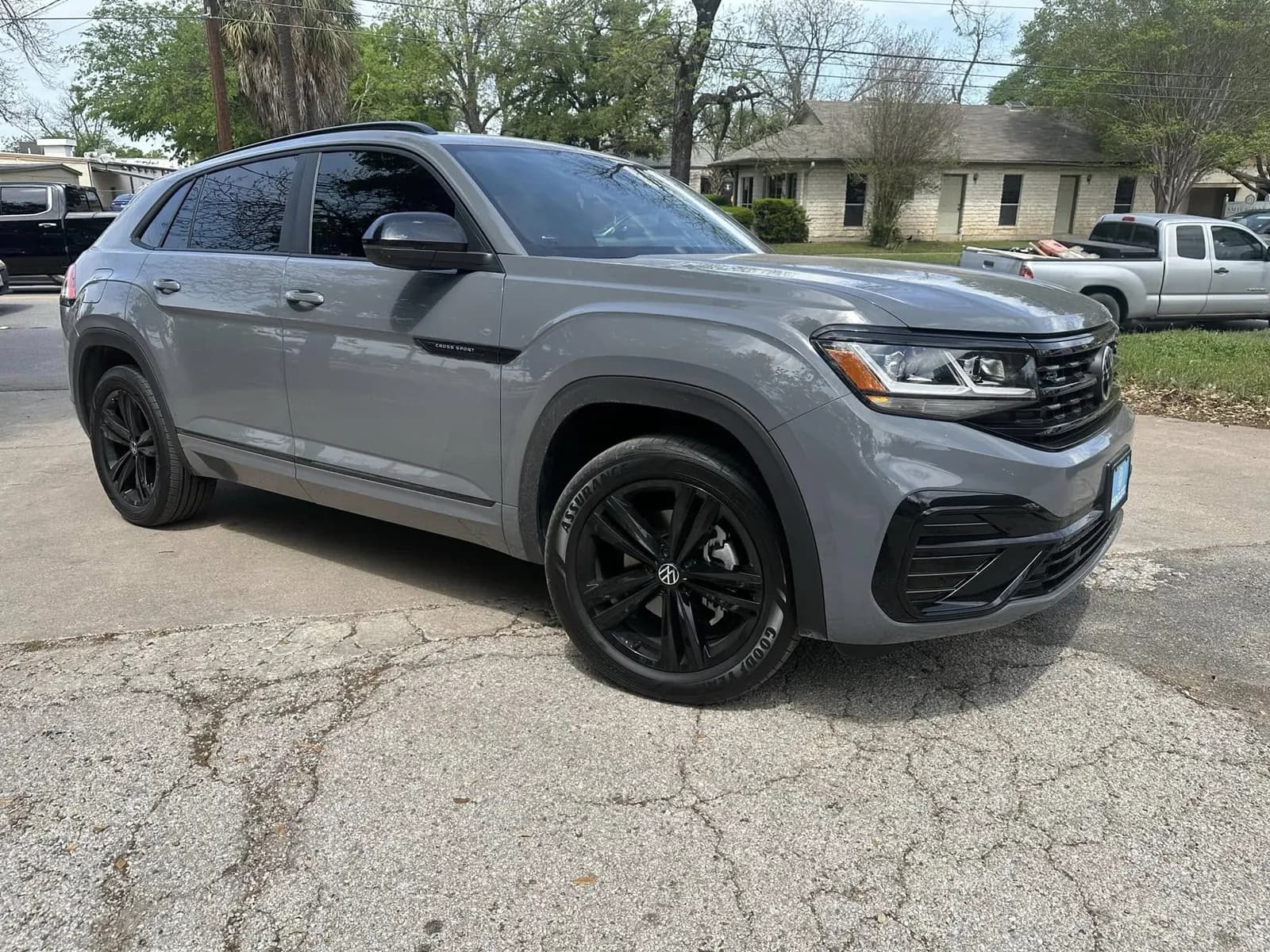 Grey VW Atlas Cross Sport with window tint installed, outside the Shade Customs shop in Georgetown, Texas