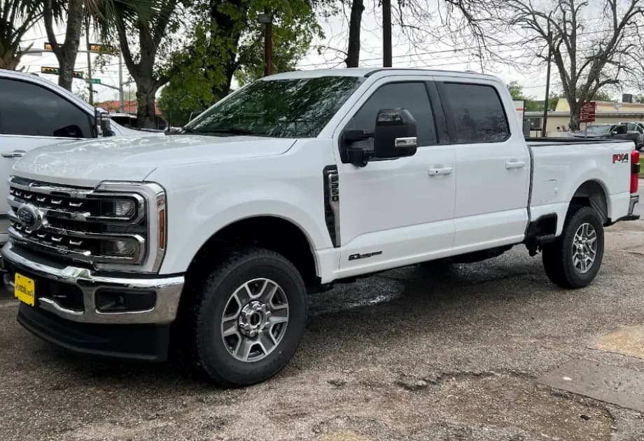 White Ford F-250 FX4 with window tint installed, outside the Shade Customs shop in Georgetown, Texas