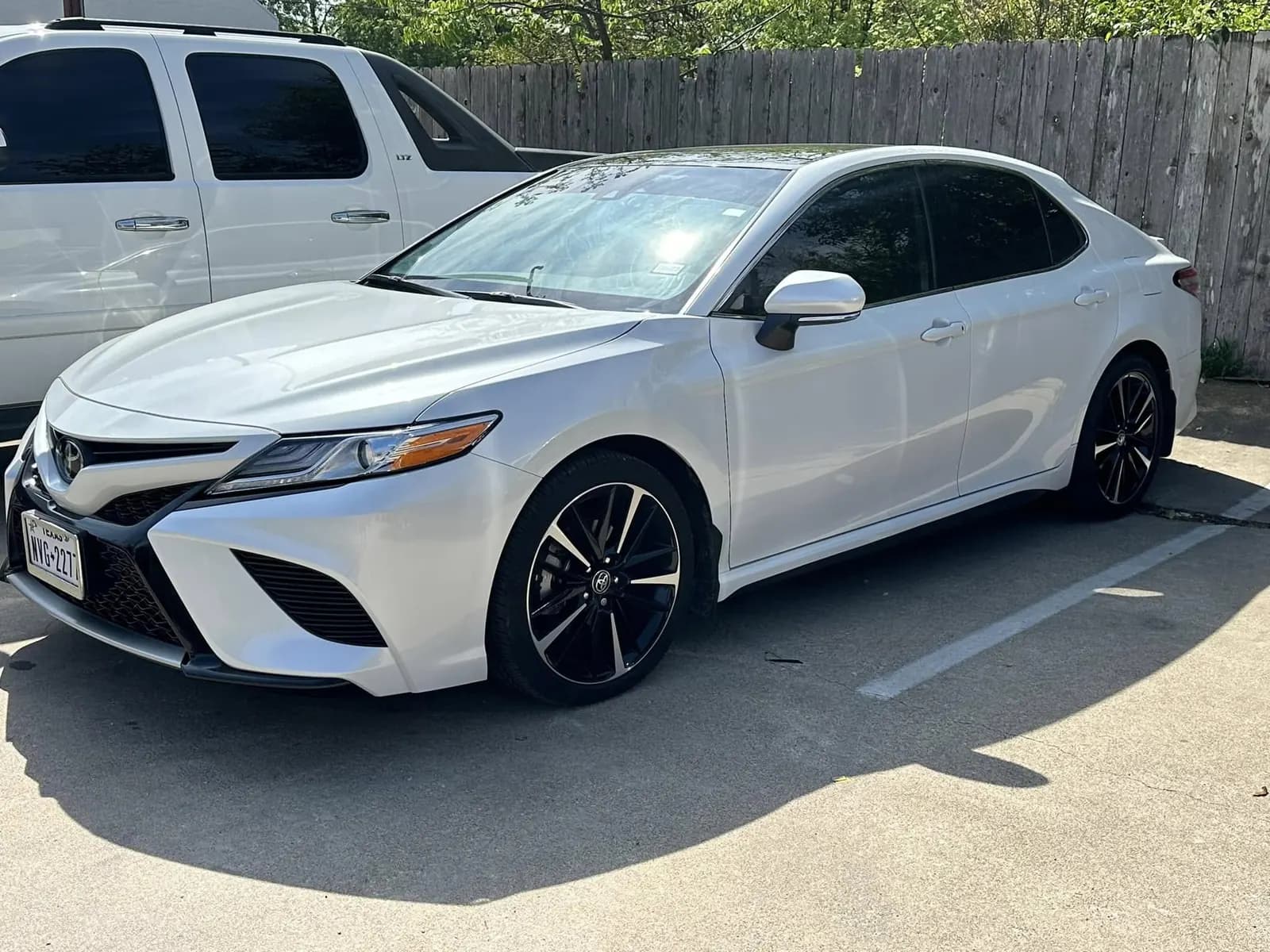 White Toyota Camry SE with window tint installed, outside the Shade Customs shop in Georgetown, Texas